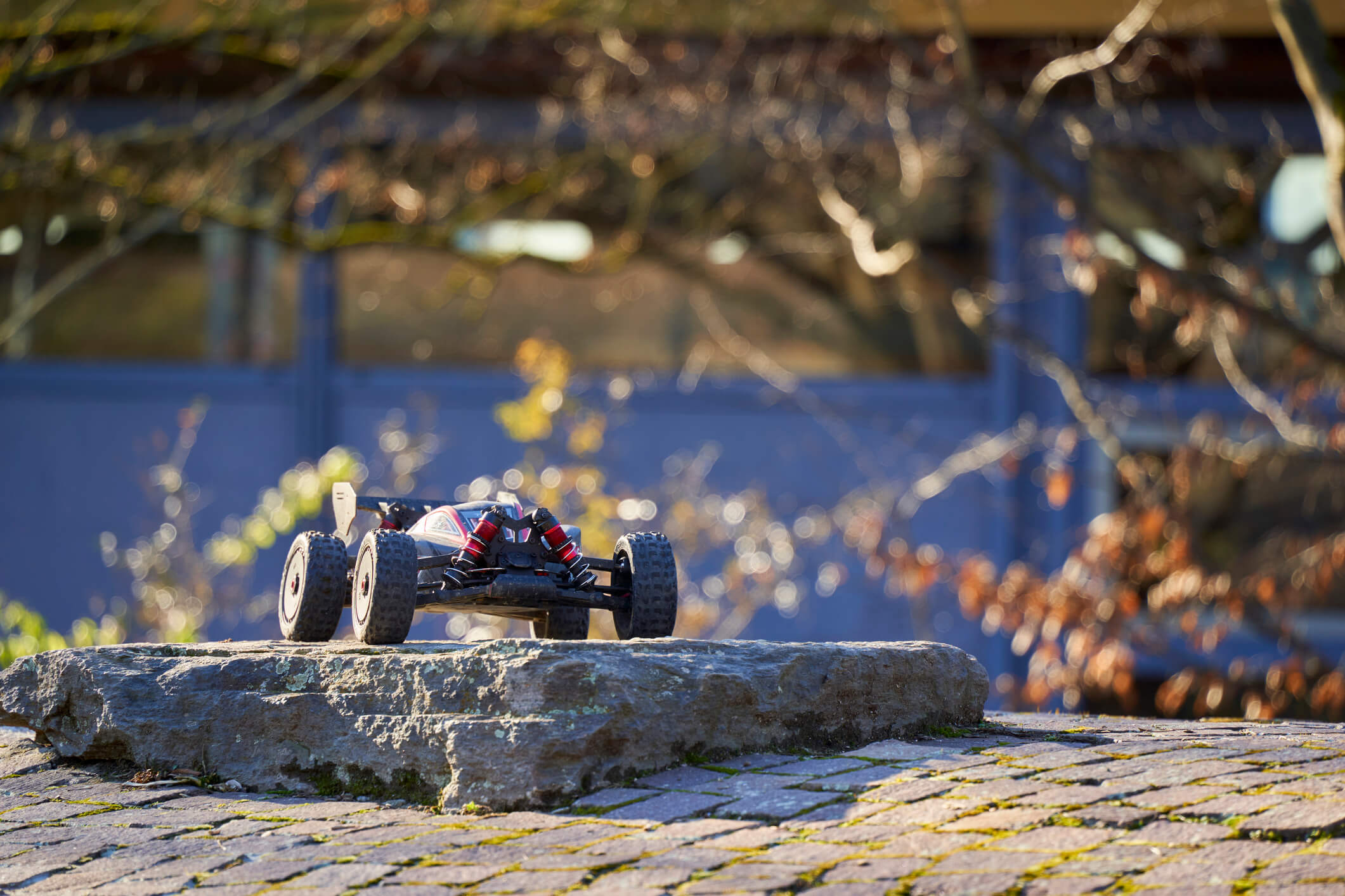  An image of an Arrma RC model Typhoon driving over rocky obstacles.